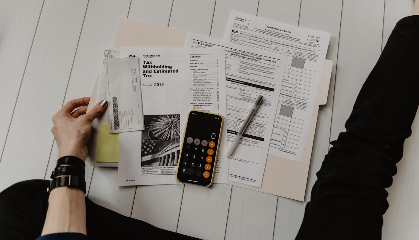 Payroll software dashboard and financial reports on a desk